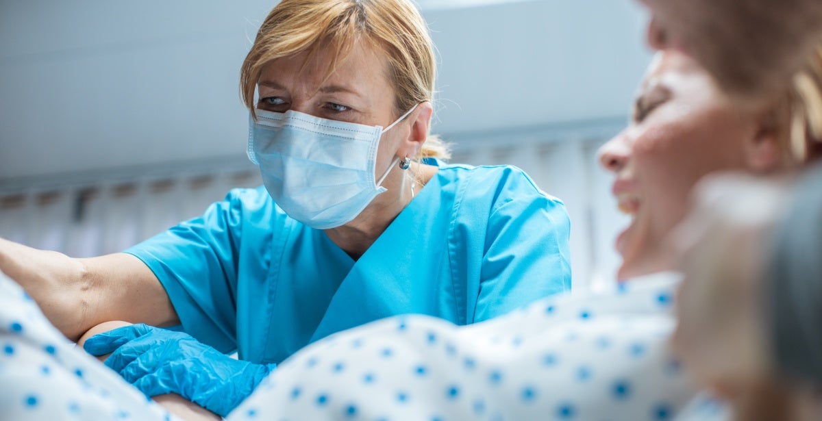 Nurse midwife helping deliver a baby