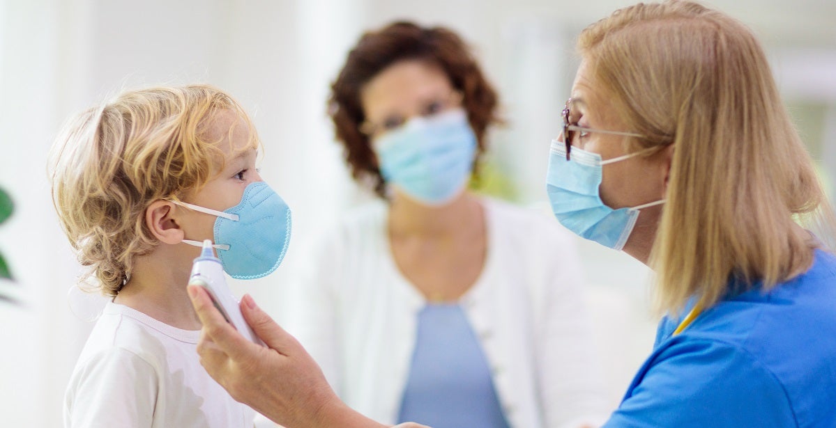 Pediatric Endocrinology Nurse measuring child's temerature